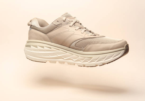istock Sport sneaker floating on beige background 2149914969