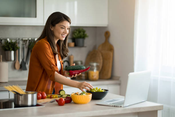 istock Woman preparing food in the kitchen while looking for tips online. 2149915919