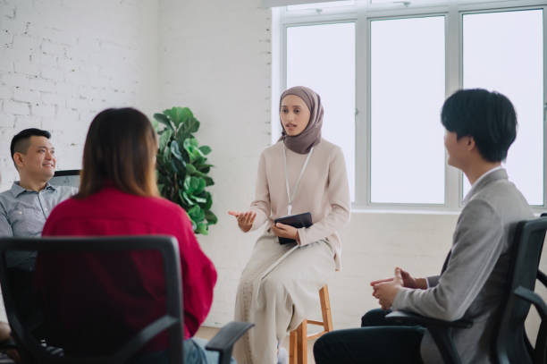 istock Anxious young woman sharing her struggles with her peers during a group therapy session 2149916050