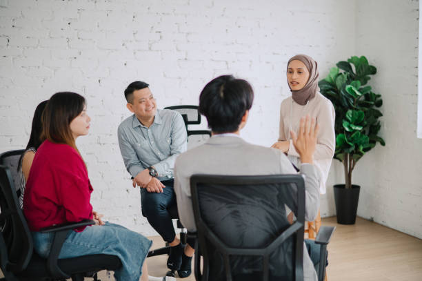 istock Anxious young woman sharing her struggles with her peers during a group therapy session 2149916060