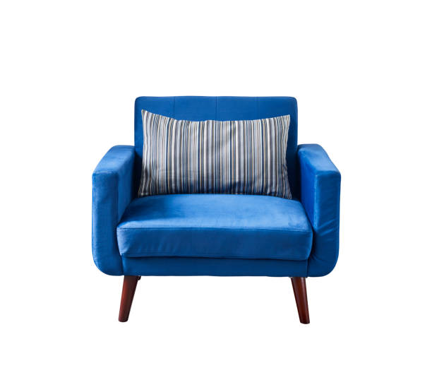 Blue armchair on yellow wall. Modern interior. Shallow DOF