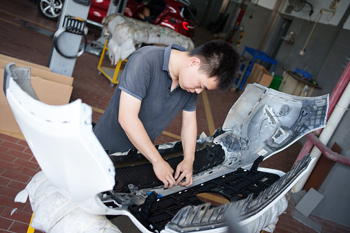 Auto parts repair worker