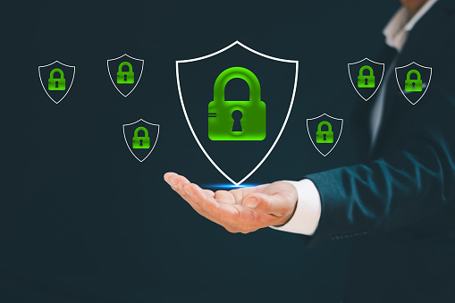 Businessman's hand showing cyber security protection shield icon. Data security and encryption Securely access user personal information Secure internet access cyber security system
