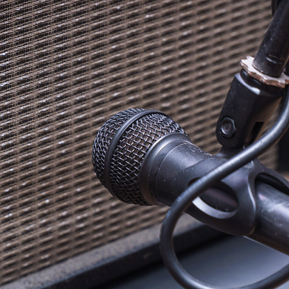 Instrumental microphone in front of the speaker of the guitar combo amplifier