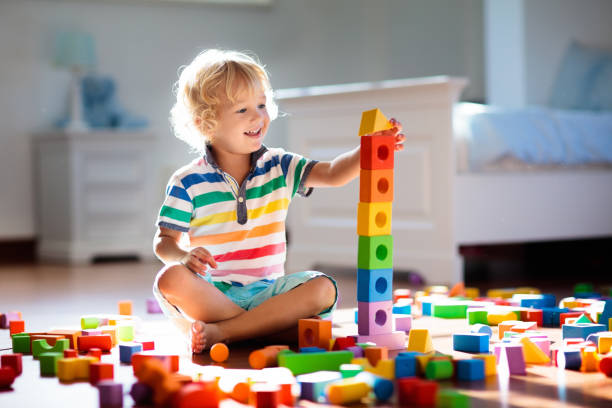istock Child playing with colorful toy blocks. Kids play. 2149921063