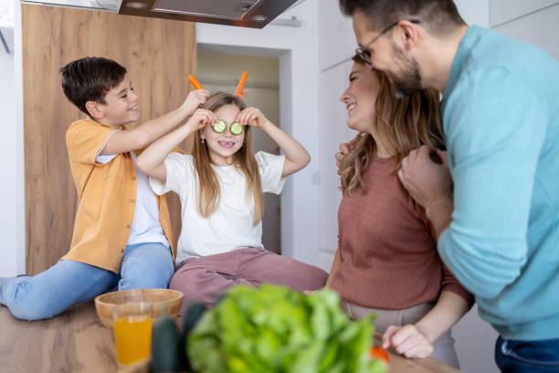 istock Family fun with carrots in the kitchen 2149923595