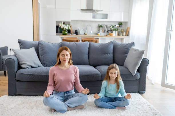 istock Mother and daughter calmly meditating together 2149924240