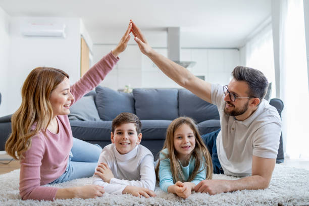 istock Joyful family forming a house shape with hands 2149924241