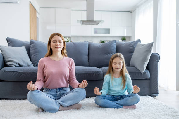 istock Mother and daughter meditating together 2149924251