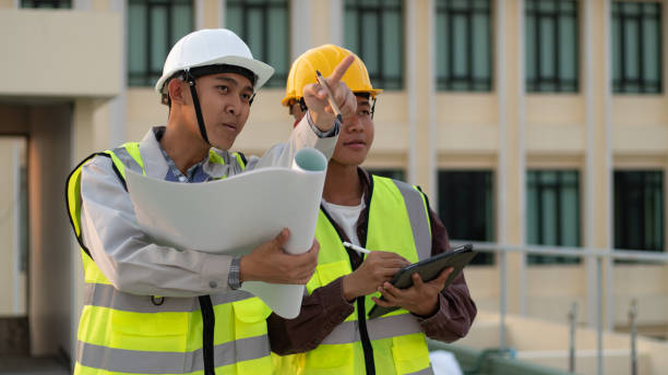 istock Structural engineer and architect working with blueprints discuss at the outdoors construction site. 2149924981