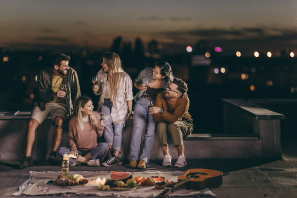 istock Cheerful friends having fun during party night on a roof. 2149925327