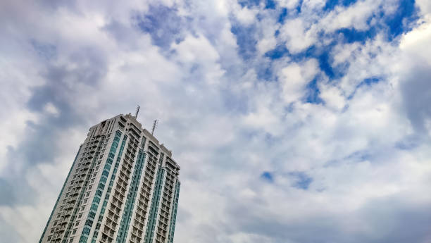 a high rise building apartment with cloudy sky copy space