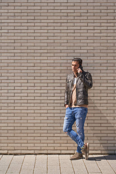istock Handsome man talking on the phone while waiting in the street 2149927267