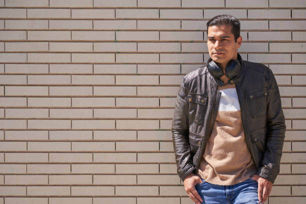 istock Handsome man putting on a headset in the street 2149927283