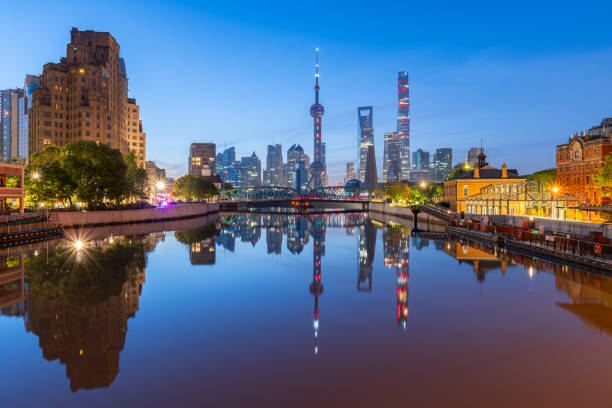 view of shanghai skyline at dawn, river and bridge