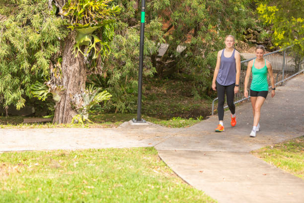 istock Young women walking together on a concrete path 2149927536