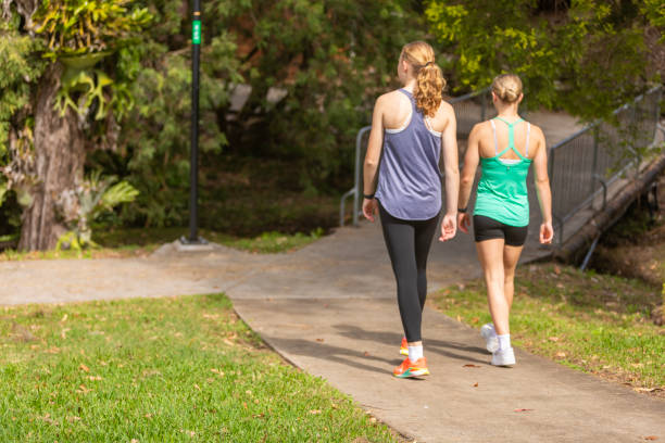 istock Young women walking together on a concrete path 2149927545