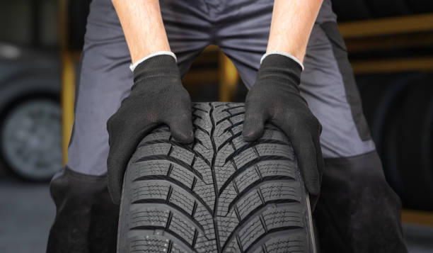 istock Car mechanic is preparing tire for change in garage. 2149928760