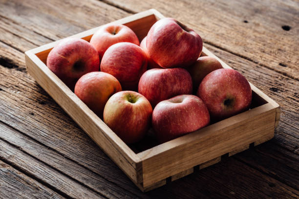 istock apple in basket on wooden background 2149929336