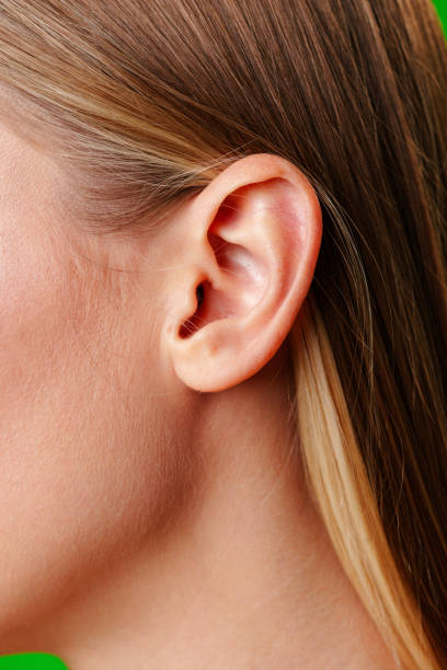 Womans Ear Close Up With Green Background close up