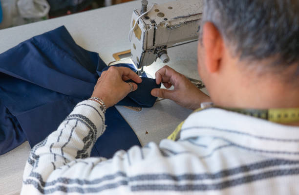 istock Man sewing a hem of pants with sewing machine 2149930315
