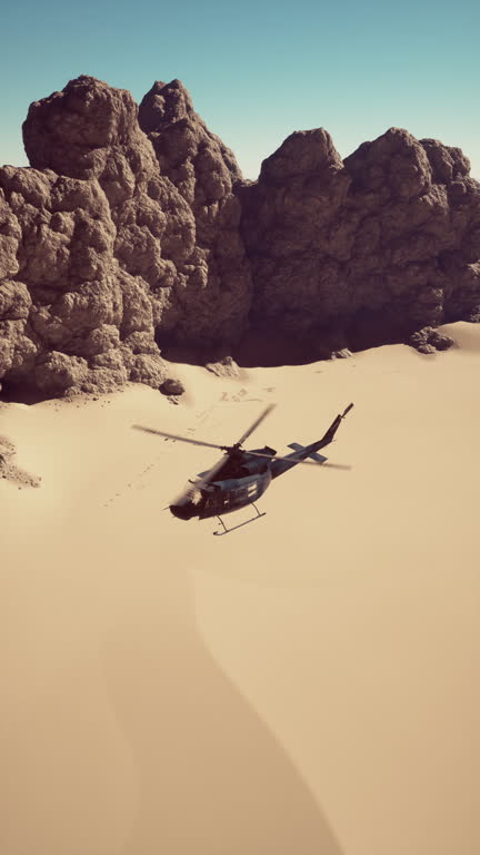 Military Helicopter Flying Over Desert Landscape