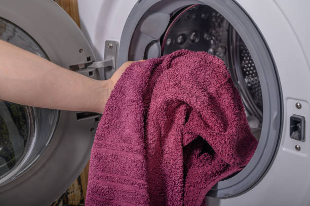 istock Do laundry, put clothes and towels into the washing machine drum 2149930780