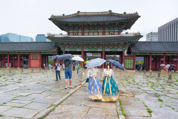 Seoul, Korea - August 15th 2019, Ladies wearing Korean Traditional Hanbok, visit Gyeongbokgung Palace at the rainy day in Downtown Seoul Korea. 서울 경복궁