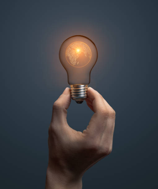 istock Artificial intelligence planet earth concept with hand holding classic light bulb glowing in the dark 2149931998