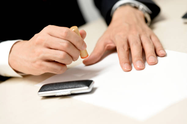 istock Hand of a man stamping a seal on a document indoors 2149932063