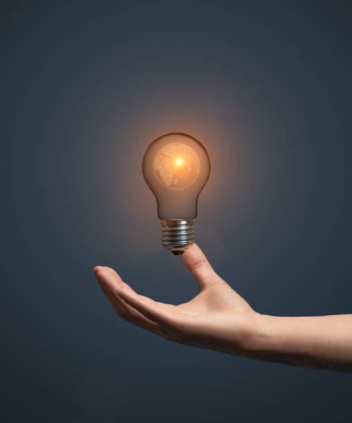 istock Artificial intelligence planet earth concept with hand holding classic light bulb glowing in the dark 2149932092