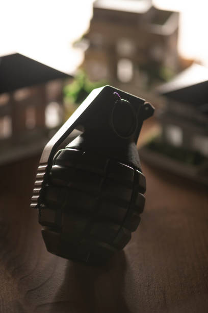 Hand grenade on textured background. Close-up. Weapons of war. Fragmentation grenade detail. Military training concept. Explosive weapon.