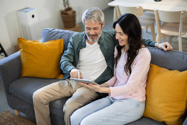 istock Happy couple using tablet and enjoying their weekend at home 2149935149