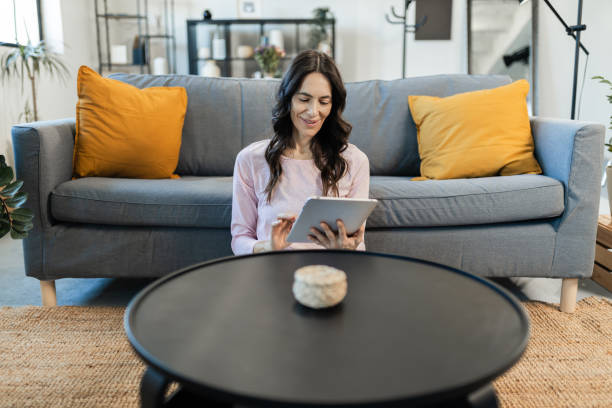 istock Woman relaxing and using tablet at home 2149935178