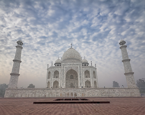 Stock photo showing hazy morning view of the formal grounds of the Taj Mahal, Agra, Uttar Pradesh, India.