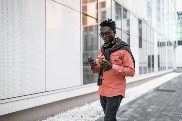 istock Young man using cell phone outdoors 2149938756