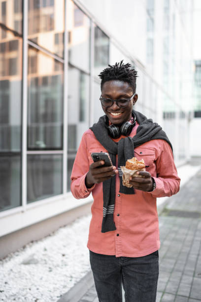 Young man using cell phone outdoors
