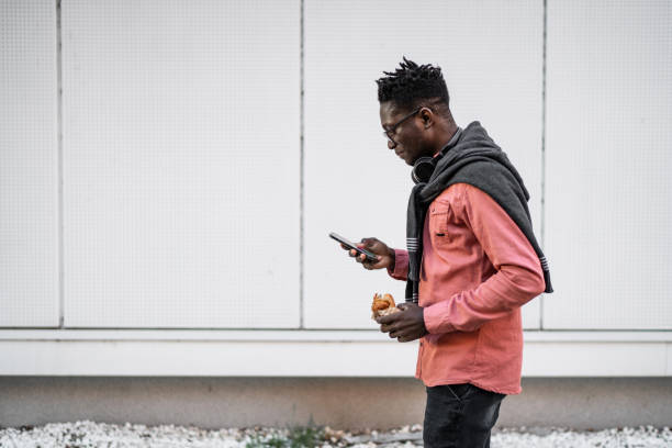 istock Young man using cell phone outdoors 2149938967