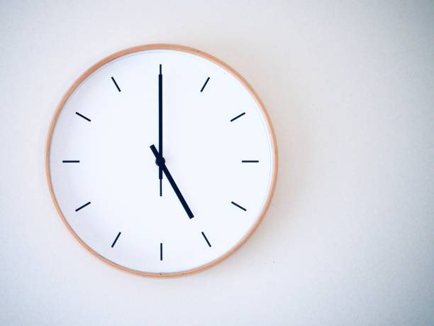 istock minimal wall clock on white show 17.00, 5.00 2149939229