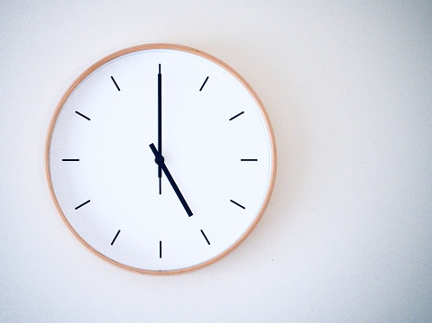 minimal wall clock on white show 17.00, 5.00