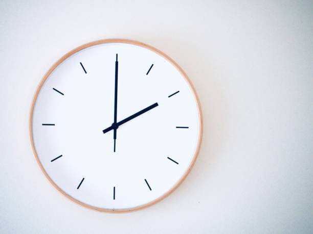 istock minimal wall clock on white show 14.00, 2.00 2149939235