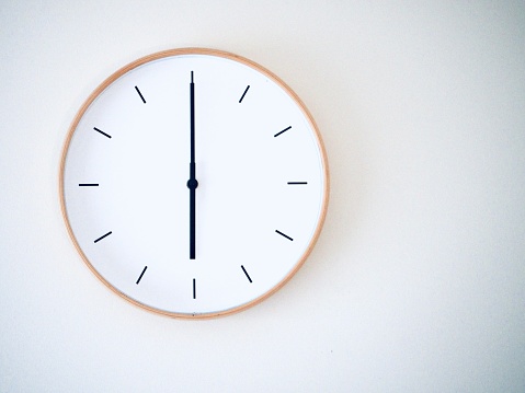 minimal wall clock on white show 18.00, 6.00