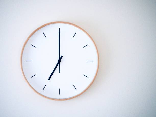 istock minimal wall clock on white show 19.00, 7.00 2149939243
