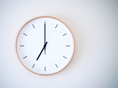 minimal wall clock on white show 19.00, 7.00