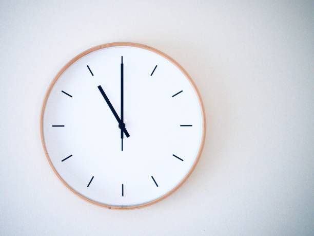 istock minimal wall clock on white show 11.00, 23.00 2149939245