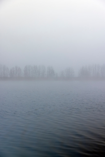 lake in winter in foggy weather, foggy day on the lake in winter season