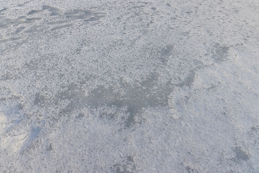 the ice-covered surface of the river in the winter season, the water frozen in the river during the frosts of the winter season