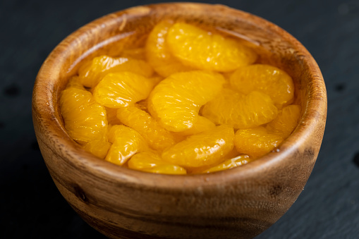 canned peeled tangerines in sugar syrup, ripe small slices of tangerines in sweet syrup