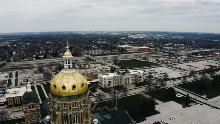 Aerial shot passing over the Iowa Statehouse on overcast day.
