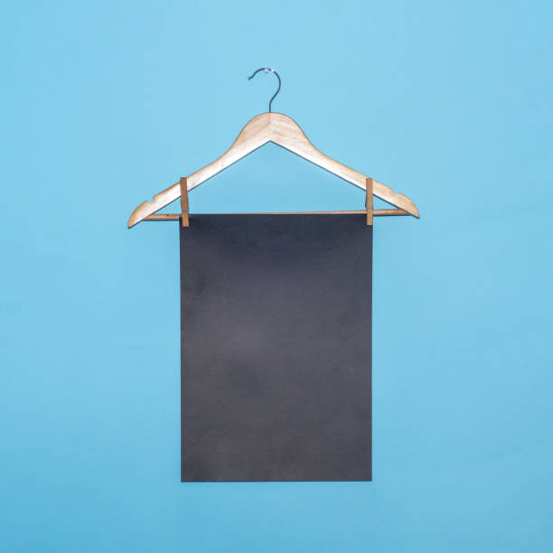 istock Black paper on a hanger creative concept with copy space on a blue background. 2149942137